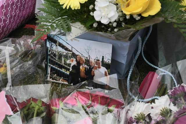 Flowers left at the scene of the fire in St James Grove, Poolstock