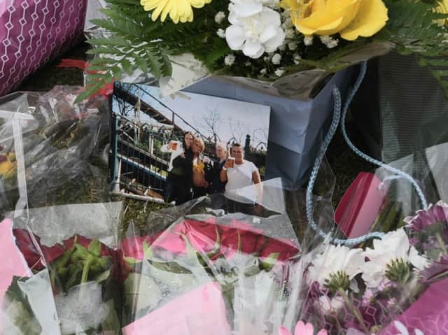Flowers left at the scene of the fire in St James Grove, Poolstock