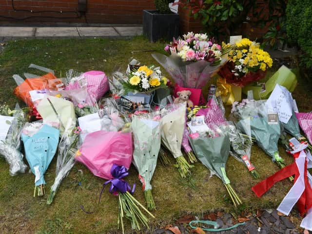 Flowers left at the scene of the fire in St James Grove, Poolstock