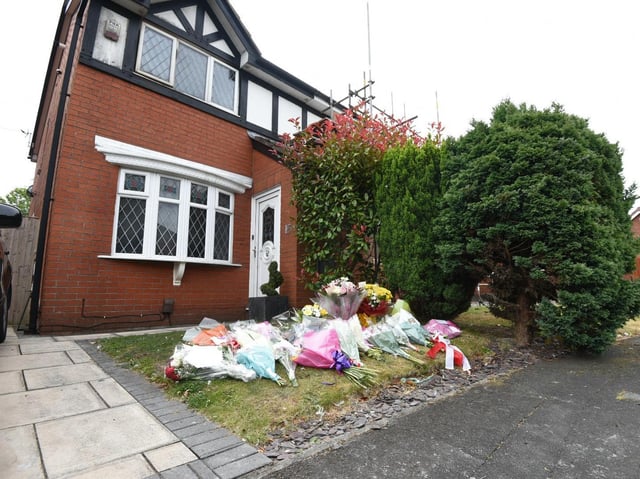 Flowers left at the scene of the fire in Poolstock
