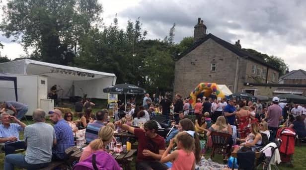 People enjoying a music festival in the former beer garden of The Old Springs