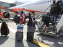 Passengers prepare to board an easyJet flight to Faro, Portugal, at Gatwick Airport