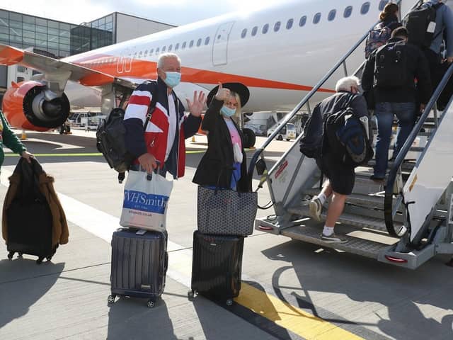 Passengers prepare to board an easyJet flight to Faro, Portugal, at Gatwick Airport