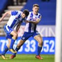 Wil Grigg celebrates his winning goal against Manchester City with Max Power