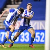 Wil Grigg celebrates his winning goal against Manchester City with Max Power