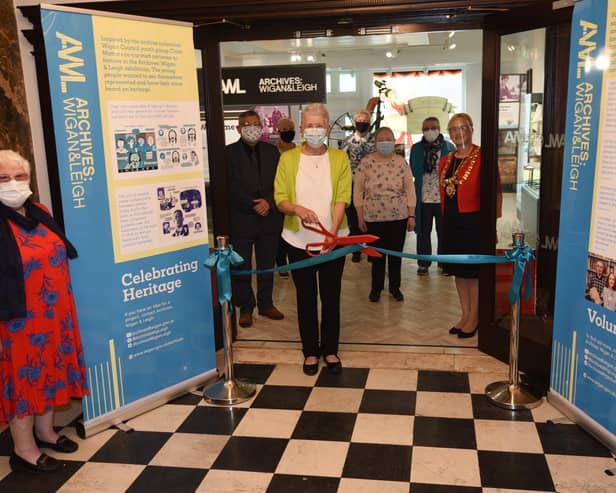 Lilian Lockwood from the U3A quilters group cuts the ribbon at Leigh Town Hall