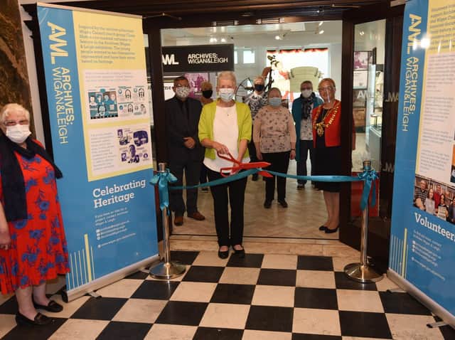 Lilian Lockwood from the U3A quilters group cuts the ribbon at Leigh Town Hall