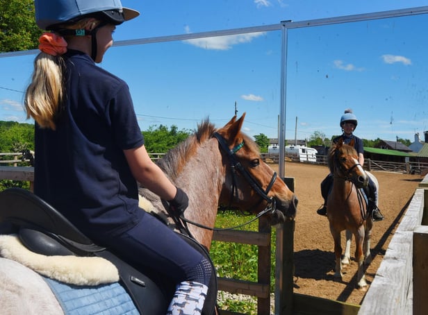 Ursula Morris, 10, on her pony Skippy, in the paddock with mirrors at Parbold Equestrian Centre