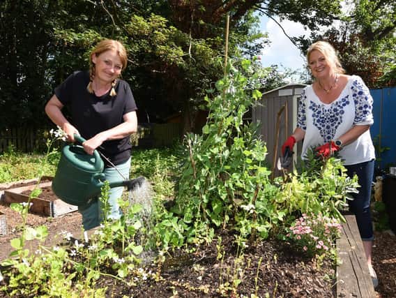 Jo Williams and Shelley Guest in the community garden