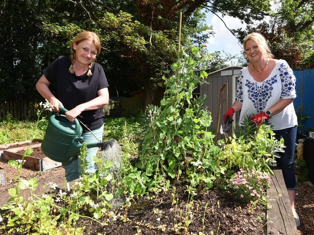 Jo Williams and Shelley Guest in the community garden