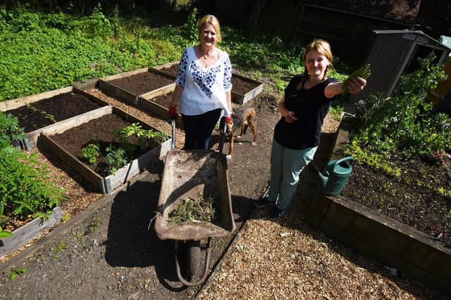 Shelley Guest and Jo Williams in the community garden