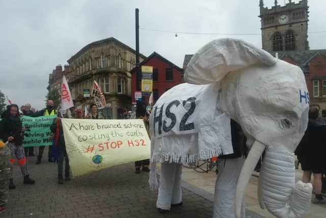 The white elephant makes its way through Market Place