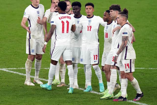 England's Marcus Rashford stands dejected with team mates after missing from the penalty spot during the penalty shoot out following the UEFA Euro 2020 Final at Wembley Stadium, London.