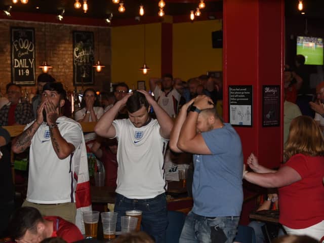Not our night - fans in Wigan react to the penalty shoot-out in the Euros final