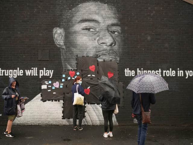 People start to cover the racist graffiti on Marcus Rashford's mural with messages of love in Withington