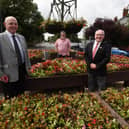 Wigan Councillors Michael McLoughlin, left, and George Davies, right, with local resident Dave Calder at the Cherry Gardens roundabout