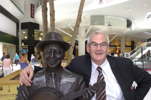 John Sanson with the George Formby statue in the Grand Arcade