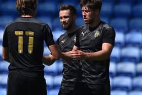 Callum Lang is congratulated after putting the Latics of Wigan 2-0 up at Oldham