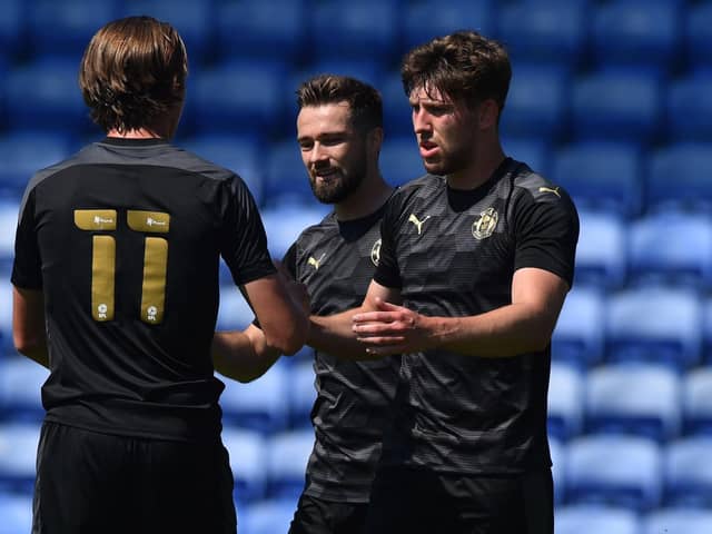 Callum Lang is congratulated after putting the Latics of Wigan 2-0 up at Oldham