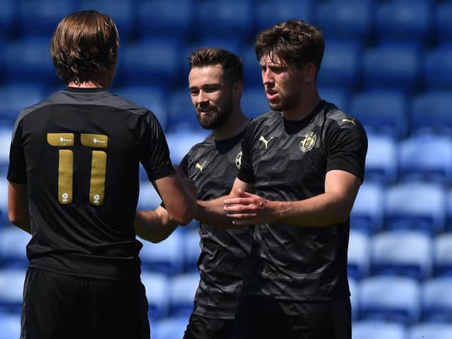 Callum Lang is congratulated after putting the Latics of Wigan 2-0 up at Oldham