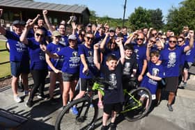 Olly Johnson cheers on the cyclists