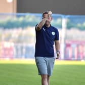 Leam Richardson acknowledges the Latics fans at Fylde