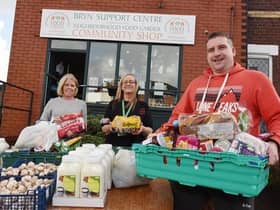 Coun Steve Jones, right, with Anthea Caffrey, left, and Gill Williams from Bryn Support Centre, food larder and community shop, offering food parcels for members of the community