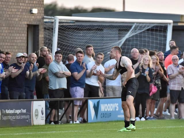 Max Power hands over his shirt to a lucky Latics fan at Fylde