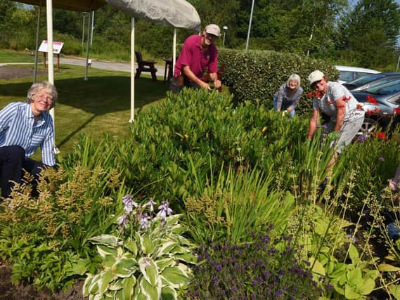 Volunteers preparing the hospice's gardens for the open day
