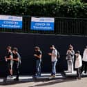 Members of the public queue outside to receive the Pfizer-BioNTech Covid-19 vaccine at a temporary Covid-19 vaccine centre