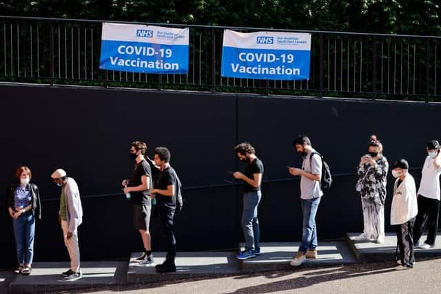 Members of the public queue outside to receive the Pfizer-BioNTech Covid-19 vaccine at a temporary Covid-19 vaccine centre