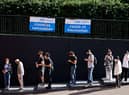 Members of the public queue outside to receive the Pfizer-BioNTech Covid-19 vaccine at a temporary Covid-19 vaccine centre