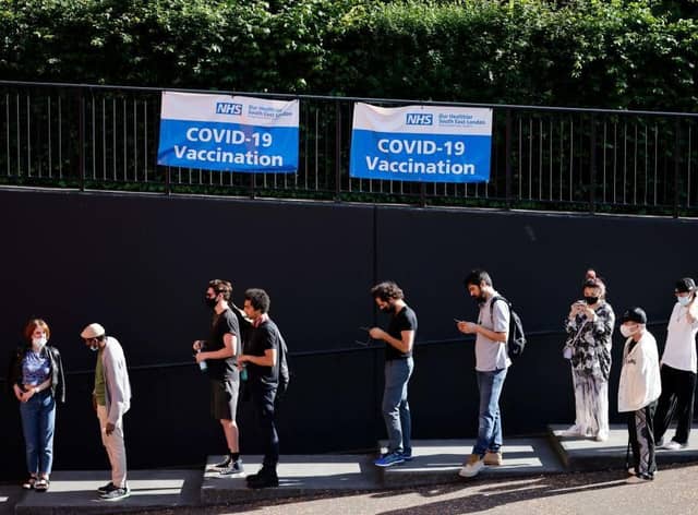 Members of the public queue outside to receive the Pfizer-BioNTech Covid-19 vaccine at a temporary Covid-19 vaccine centre