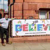 Councillors Chris Ready and Keith Cunliffe with a banner