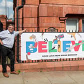 Councillors Chris Ready and Keith Cunliffe with a banner