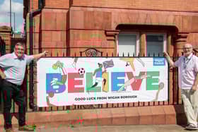 Councillors Chris Ready and Keith Cunliffe with a banner