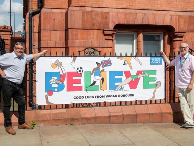 Councillors Chris Ready and Keith Cunliffe with a banner