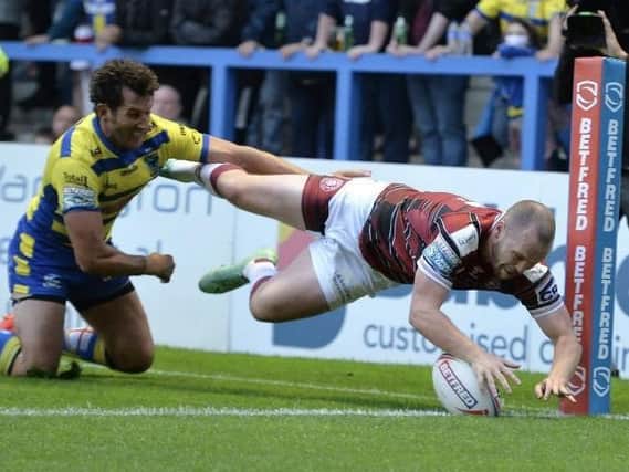 Liam Marshall scores the first of his two tries at Warrington