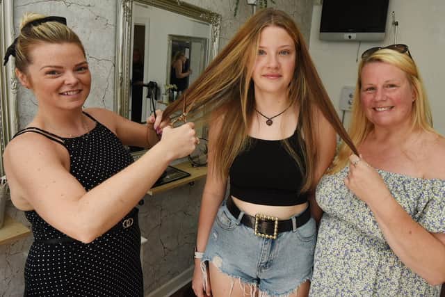 Molly Catterall, centre, with Leah-Marie Thompson, owner of Leah-Marie Hair and Beauty, Hindley and mum Karen Winterflood