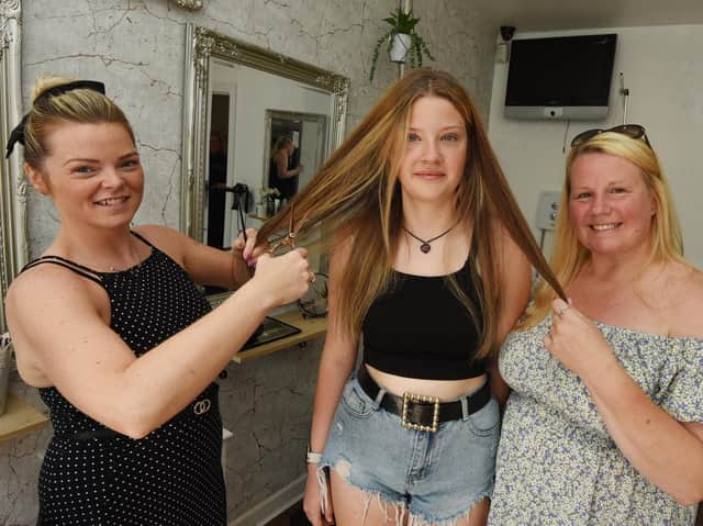 Molly Catterall, centre, with Leah-Marie Thompson, owner of Leah-Marie Hair and Beauty, Hindley and mum Karen Winterflood