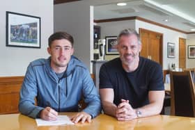 James Carragher signs pro forms with Latics, watched by his proud dad Jamie