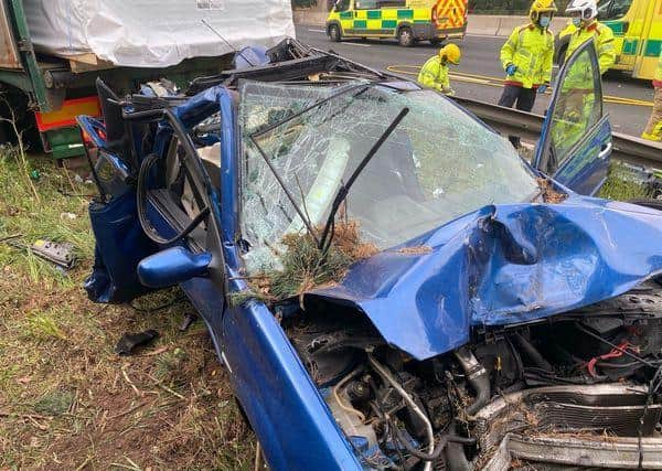 Firefighters used cutting equipment to remove the doors of the car before rescuing four people. (Credit: Knutsford Fire Station)