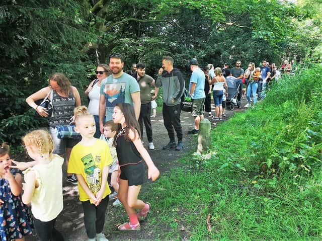 Families queue for a ride on the train