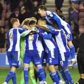 The Latics players enjoy that winning feeling against local rivals Bolton