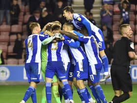 The Latics players enjoy that winning feeling against local rivals Bolton