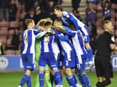 The Latics players enjoy that winning feeling against local rivals Bolton