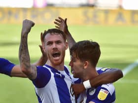 Callum Lang is mobbed by former Pompey man Tom Naylor