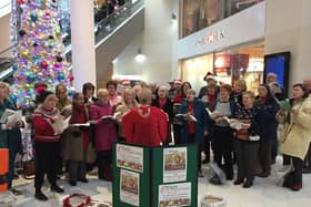 Members of WIgan Choral Society serenading Christmas shoppers in the Grand Arcade in per-pandemic times