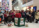 Members of WIgan Choral Society serenading Christmas shoppers in the Grand Arcade in per-pandemic times