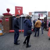 Fans gather outside Old Trafford cricket ground after the final Test match between England and India was canceled